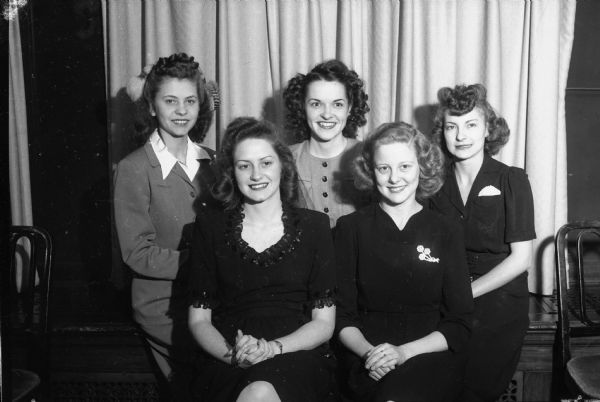 Group portrait of Unit One of the Nu Phi Mu Sority. Left to right: Elaine Wilke, recording secretary; Gloria Lemmel, corresponding secretary; Gerry Garthwaite, treasurer; Barbara Scott, president; and Alice Johnson, vice president. The sorority is composed of young working girls and is a junior auxiliary to Beta Sigma Phi, a non-academic international women's friendship organization, with three chapters in Madison.