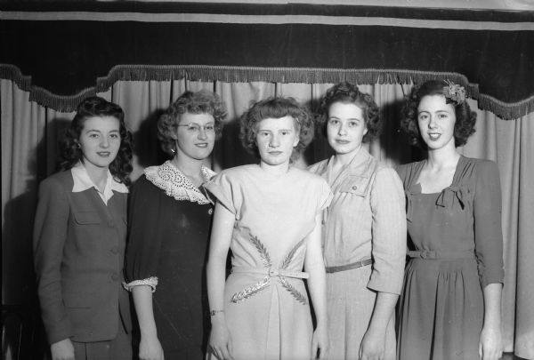 Group portrait of Unit Two of the Nu Phi Mu Sority. Left to right: Rose Marie Murphy, treasurer; Alice Williams, president; Peggy Fox, vice president; and Jackie Hilgers, recording secretary.  The sorority is composed of young working girls and is a junior auxiliary to Beta Sigma Phi, a non-academic international women's friendship organization, with three chapters in Madison.