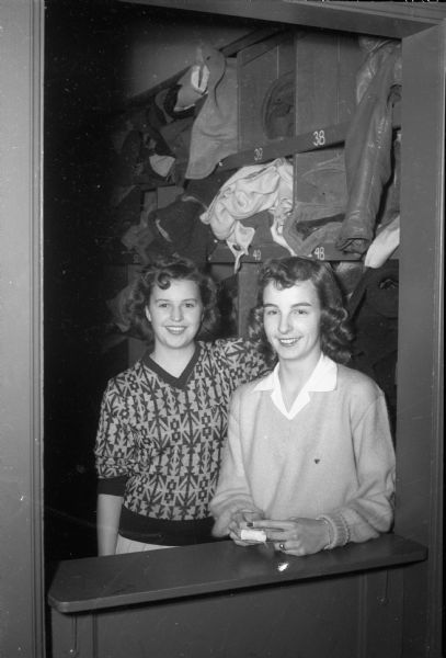 Two girls checking coats at the opening of the LOFT, left: Ruth Richards, 2210 East Johnson Street; Barbara John, 1517 Spaight Street.