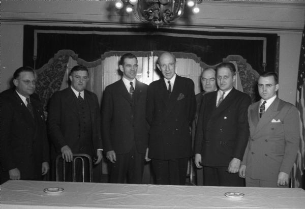 Ambassador Lord Halifax, British ambassador to the United States, meeting with Madison and Wisconsin labor leaders. Lord Halifax is in the center, and to the left: Arnold Zander, President of the American Federation of State, County, and Municipal Employees; and to the right: Clifford Johnson, of the Gisholt Union. Four other labor leaders are in the group portrait.