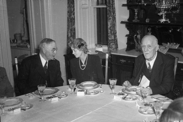 Lady Halifax conversing with Chief Justice Rosenberry while dining. Governor Walter Goodland is on right.