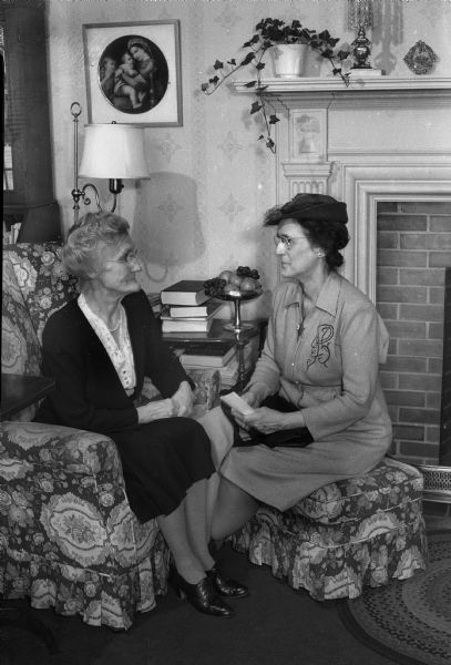 Miss Harriette Holt on the left, and Mrs. Warren W. Clark on the right, at the birthday party held for Miss Ellen Sabin, president emerita of Milwaukee-Downer College. Miss Holt formerly taught mathematics at Milwaukee-Downer College and now is assistant professor of mathematics at the University of Wisconsin extension division.