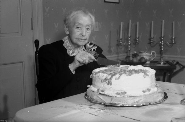 Miss Ellen Sabin, president emerita of Milwaukee-Downer College, cutting the birthday cake at her 94th birthday party hosted by the Milwaukee-Downer club of Madison.  She was born on Nov. 29th, 1850.