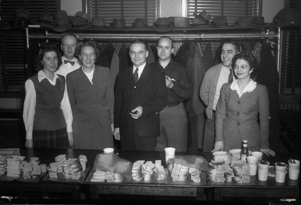 Seven people at the food table at a First National Bank party.