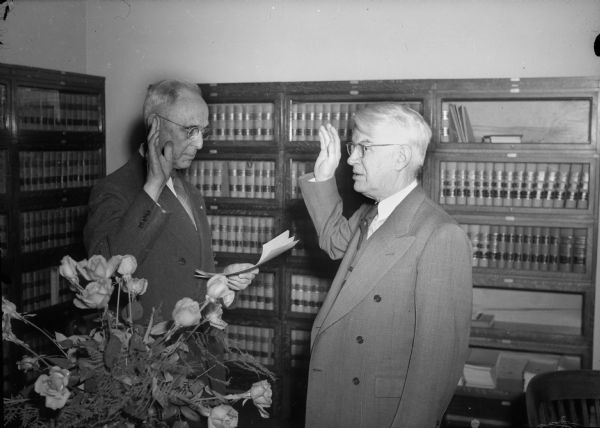 Charles H. Cashin (right) of Stevens Point being sworn in by Clerk of Court Herbert C. Hale as the U.S. Attorney for the Western Wisconsin District.