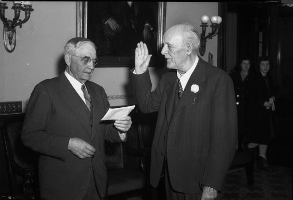 Chief Justice Marvin E. Rosenberry administers the oath of office to Walter S. Goodland, Governor-elect of the State of Wisconsin.