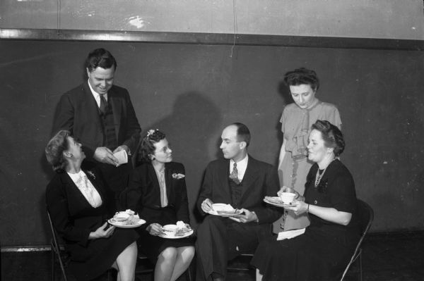 Nakoma Welfare League's traditional Twelfth Night Party at Nakoma School. Pictured are some of the people who assisted with the party arrangements: left to right, Mrs. T. Roy (Lena) Truax, Prof. Gerald E. Annin, Mrs. Perle Knope, Sidney E. Knope, Mrs. Ivan (Gertrude) Fay, Mrs. John D. (Nita) Howard.