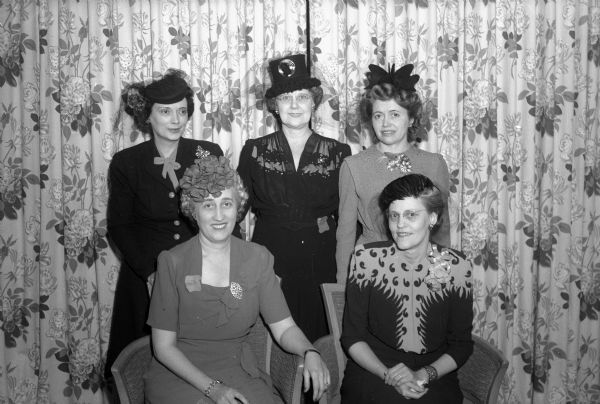 Five former presidents of the Who's New Club celebrate the tenth anniversary of the organization. Sitting are: Mrs. (Helen) Edwin B. Nylen, Mrs. R.C. Klussendorf; standing are: Mrs. (Louise) R.W. Blaha, Mrs. (Evelyn) J.P. Woolsey, Mrs. (Evelyn) B.H. Scott.