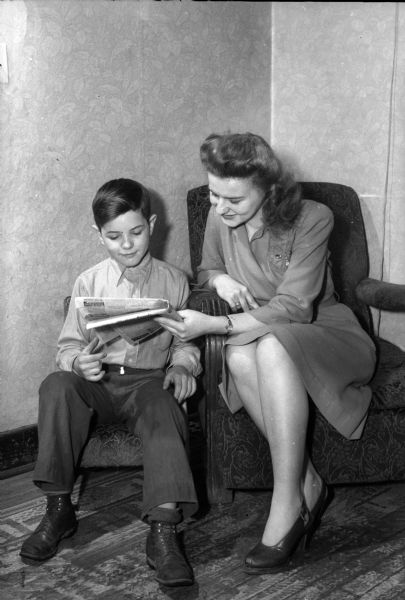 Lorraine Gray, and her younger brother Frank are reading an RMR "help wanted" advertisement in the "Wisconsin State Journal." The RMR (Ruben-Mallory-Ray-O-Vac) plant, a division of Ray-O-Vac was located in the 1400 block of East Washington Avenue. The plant manufactured batteries for walkie-talkies used for the military during World War II.