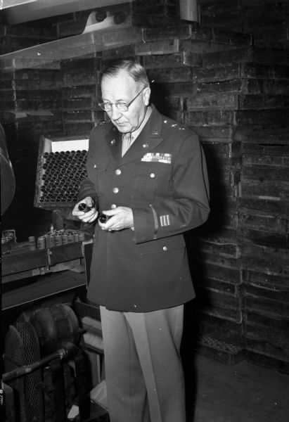 Maj. Gen. Harry C. Ingles, Chief Signal Officer, United States Army, inspecting batteries at Ray-O-Vac, or RMR (Ruben Mallory Ray-O-Vac).