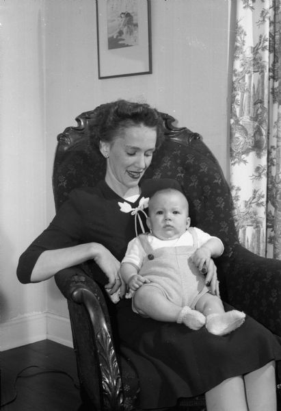 Portrait of Mrs. F. Chandler Young (Helene Schuette), and her infant son Frank Chandler Jr., who were visiting her parents, Prof. and Mrs. Henry A. Schuette, Maple Bluff, with her husband, Lt. Young, while he  was on furlough during World War II.
