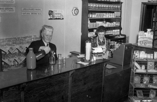 Clerks behind the counter at the Fridblom Health Foods Store, 120 East Washington Avenue.