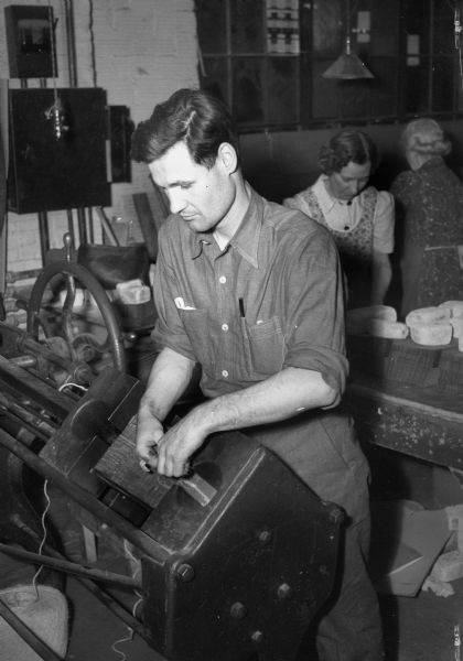 Leonard Smith, a blind employee, working at Forsberg Box Company.