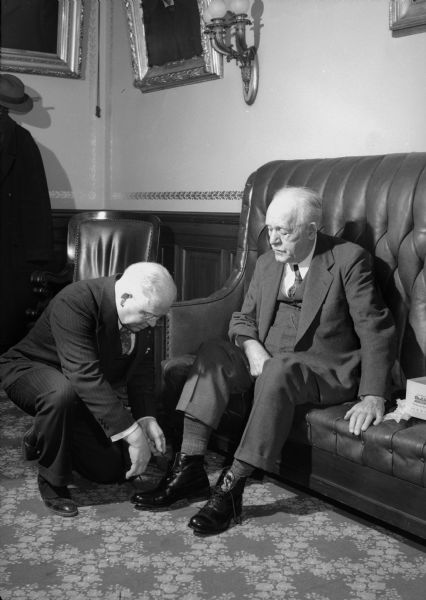 Governor Walter S. Goodland is fitted for a pair of custom-made shoes by Dr. A. Reed.
