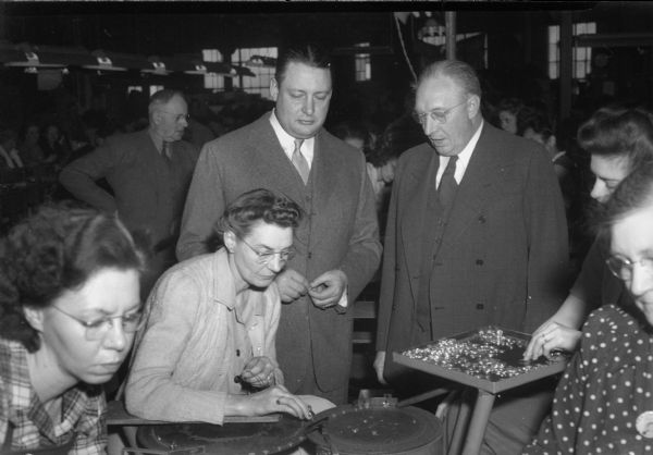 William W. Cargill, President of Ray-O-Vac, and a Mr. Krug, watching company employees making electric batteries.