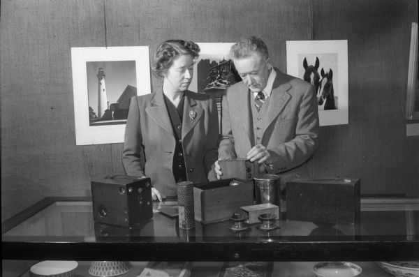 Mrs. Walter (Dorothy) Frautschi, representing the Madison Art Association, and Professor Warner Taylor, viewing the photographic exhibition at the State Historical Society's Museum. Prof. Taylor is a photographer whose work is shown in national and international exhibitions.