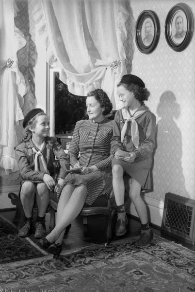 Mrs. Austin T. Breyer (Daisy), 2730 Lakeland Avenue, ordering Girl Scout cookies from Scouts Mary Ripp, left, 2202 Lakeland Avenue, a member of Troop 12 of St. Bernards School, and Susan Lerdahl, 2401 Center Avenue of Troop 78, at Lowell School. The first Madison cookie sale was in 1928.