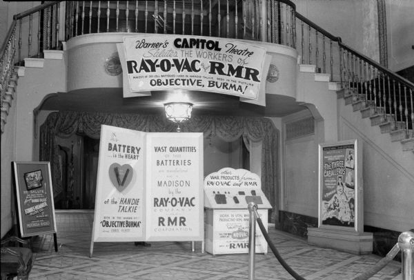 Ray-O-Vac & RMR promotional exhibit set up at the Capitol Theatre.  
"This battery is the heart of the Handie Talkie seen in the Warner hit 'Objective Burma' ".