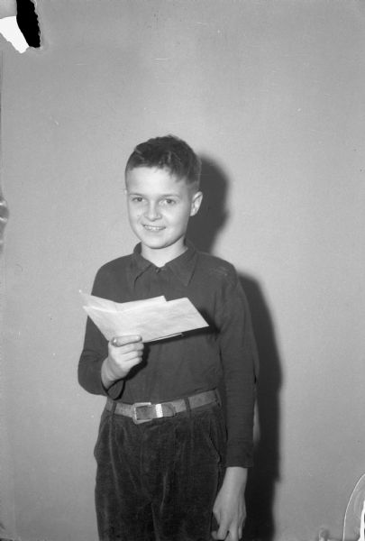 Roger Mott, son of Mr. and Mrs. Donald B. Mott, 20 Lathrop Street, holding a letter he received from General Douglas MacArthur in the Philippines.  Roger, a student in the sixth grade at Edgewood school, received the letter on his twelfth birthday.