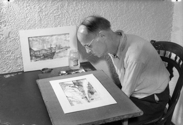 Alex Hardie painting a watercolor with the brush held between his teeth. Alex lost portions of both arms in a railroad accident in 1900.