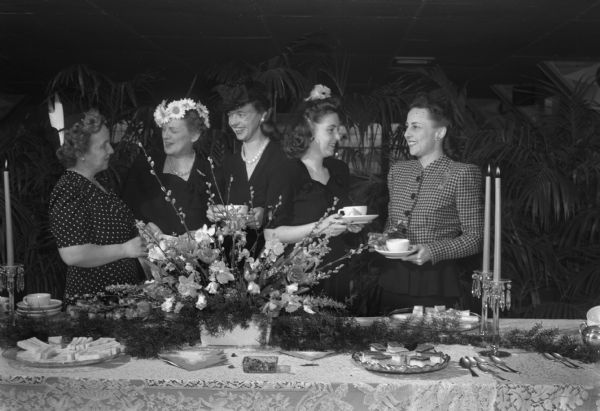 The Women's Club sponsored tea for officers wives of all services at the Officers Club of Truax Field. Left to right: Mrs. Oscar B. Wallace, Mrs. Roscoe ??, Mrs. Francis ??, Mrs. Robert ??, Mrs. Charles S. Stubbs.