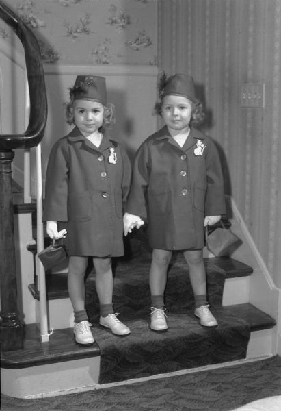 Jane and Janet Brandenburg, twin daughters of Mr. and Mrs. (Marian) Harold Brandenburg, 4134 Hiawatha Drive, posing in their identical Easter outfits.