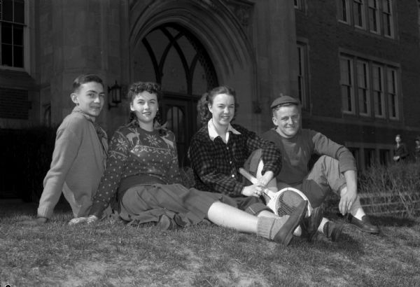 Four East High School students dressed in casual attire. From left to right: John Deauchamp, Jr., Marjorie Ensign, Georgiana Browne, and Don Stevens. 
