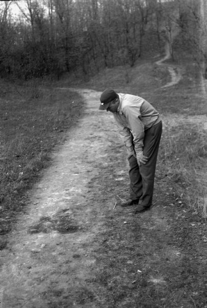 A.M. Mickelson, 10 N. Owen Dr., inspecting the scene of the explosion at the base of Sunset point where three Madison boys were badly burned while playing with dynamite.