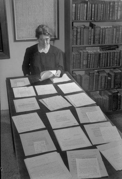 Margaret Smith, secretary of the Madison and Wisconsin Foundation, surveys a few of the letters received from servicemen who trained in Madison and plan to return here to live.