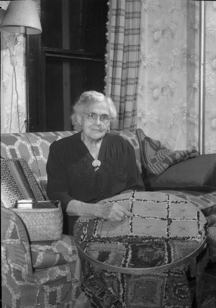 Portrait of Ella M. Pickford (Mrs. Henry W. Pickford), 201 South Mills Street. Mrs. Pickford, who is 88 years old, does her own housework and despite poor eyesight, still hooks rugs.
