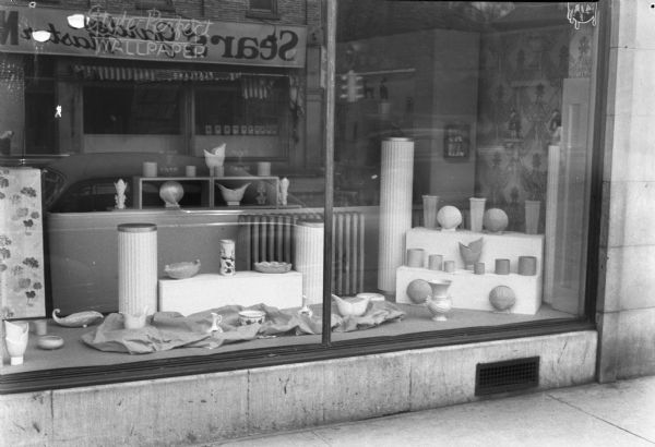 Show window at Sherwin Williams Paint Store, 327 State Street, featuring pottery.