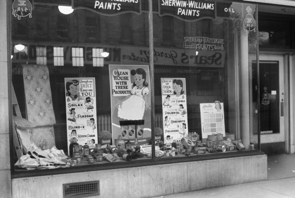 Show window at Sherwin Williams Paint Store, 327 State Street, featuring house-cleaning products and a poster that says "Clean House with These Products".