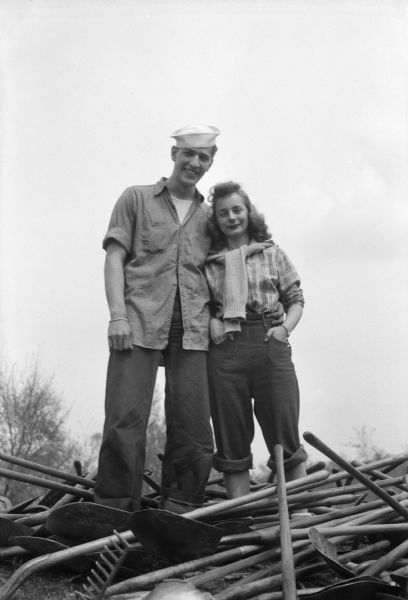 Annual University of Wisconsin-Madison student work day project located at Picnic Point. Shown posing together are the chosen "blue jeans" king and queen for the event, Charles Dunfee, with sailor hat, and Gloria Glander.