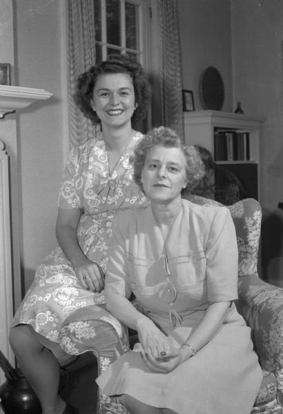 Mrs. John (Esther) Mayer, on the left, with her mother Mrs. Harold (Iva) Marsh, at the Marsh home. Mrs. Mayer is staying at the home of her parents while her husband, a captain in the army signal corp, is serving "somewhere in the Pacific".
