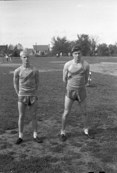 Madison West High School track team first place winners in Wisconsin State Track tournament. On the left is Tom Yorkson, winner of the 880, and on the right, Bob Mansfield, winner of the 440.