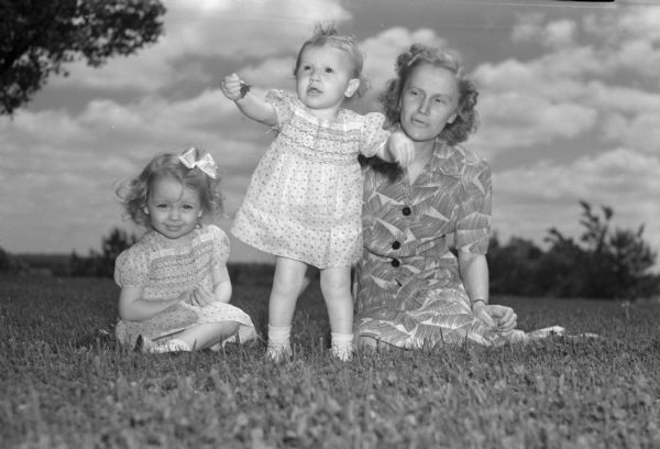 Mrs. Joseph P. O'Brien, 1627 Jefferson Street, with her two daughters, playing in Vilas Park. Pictured left to right: Sharon Anne 2 1/2, and Mary Kay 1, who has just learned to walk, and Mrs. O'Brien.