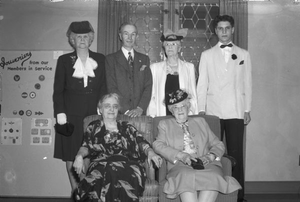 Portrait of five "Old Grads" of Madison Central High School, guests of the 1945 graduating class, the 100th group to receive diplomas from that school. Sitting left to right: Catherine Corscot and Mrs. Lucy Herfurth Harrison. Standing left to right: Mrs. John H. Findorff (Anna), Frank W. Karstens, and Mrs. Clara B. Flett. Standing at far right is Don Schiro, president of the class of 1945.