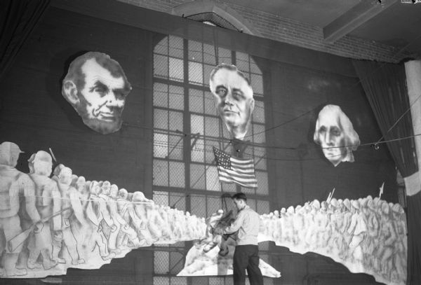 An East High School student shown with images of the presidents Washington, Lincoln, and Franklin Roosevelt, a depiction of an Iwo Jima flag raising and two rows of troops. The background is for the East High School graduation program "Tomorrow is Ours".