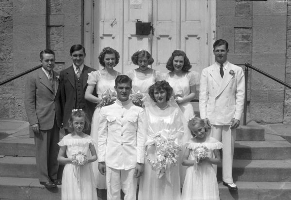 Group portrait of Coleman wedding party. The groom is in a WWII uniform.