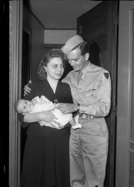 Family portrait of Pvt. Wilbur J. Hoxie, 1018 Vilas Avenue, his wife, Mildred, and their baby daughter, Roberta. Pvt. Hoxie has just returned home from Camp Grant in Rockford, Illinois.