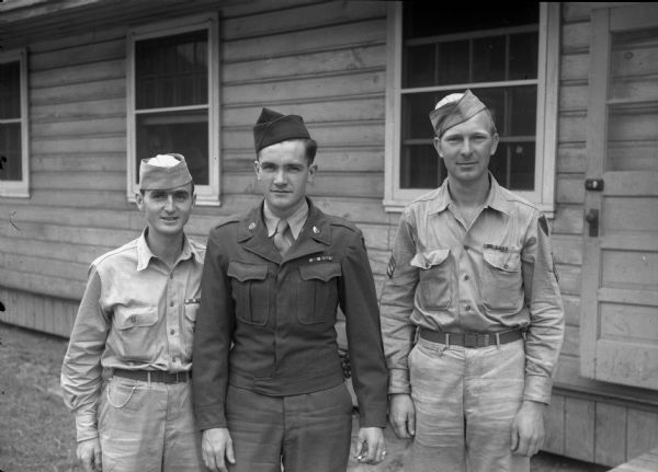 Three Madison area GIs, left to right: technican fifth grade Homer McKnight, 153 Dunning Street; Pvt. Shirley Klicko, son of Mr. and Mrs. Arthur Klicko, New Liston, and Sgt. Oscar Listol, son of Mr. and Mrs. Thorvald Listol, Stoughton. The three men have just returned home from Camp Grant in Rockford, Ilinois.