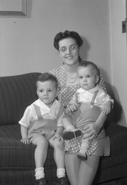 Portrait of Mrs. Donald W. (Ruth Wilson) Rindt and sons, Jon (3) and Brian (1). She's was staying with her parents, Mr. and Mrs. C.N. Wilson, prior to joining her husband, Lieut. (jg) Donald Rindt, in Norfolk, Virginia.