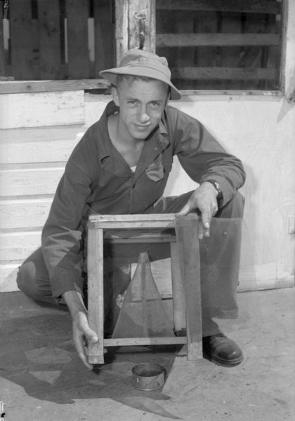 Pfc. Glen Lindsey displays the fly traps he invented to trap thousands of flies in the Truax Field area.