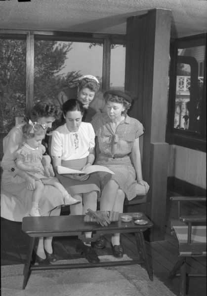 Members of the Spanish Refugee Benefit Committee are shown planning for the event. Mrs. Robert Seidl and daughter Lynn on the left, Mrs. Frank Rentz, Mrs. W.A. (Rosalie) Morton, and standing, Mrs. Melburn Heirug.