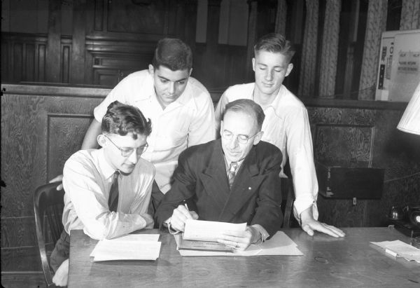 Group portrait of Frank P. Cockrell, secretary of young men at the Madison YMCA, and three young men. From left: John Farman, Nimmer Adamany, Frank Cockrell, and Bernard Cook.