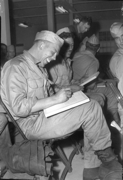 Staff Sargent Michael Linley, Mazomanie, filling out a questionnaire at Camp McCoy prior to departing for his home for a 30-day furlough before re-deployment to the Pacific.