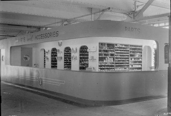 The "Parts and Accessories" counter at the Pyramid Motor Company, 434 W. Gilman Street.  The design of the counter is of the Art Deco style.