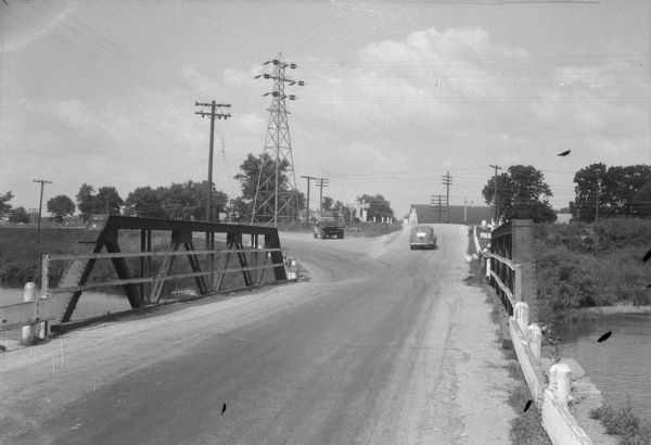 State Highway 113 bridge over the Yahara River in Westport. The photograph is taken from the south end of the bridge showing the highway going straight ahead and County Trunk Highway M curving to the left. This bridge has been called the death bridge because six people have been killed in traffic accidents there in eight weeks.