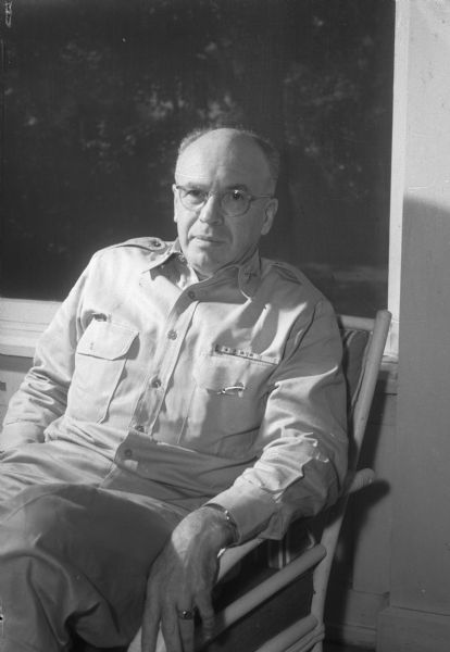 Informal portrait of Mr. Sherman seated in a chair.