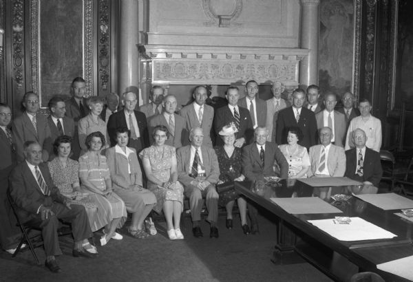Group portrait of Red Cross volunteer organizers of state employees, who will begin the annual packing and shipping of 21,000 Christmas packages to wounded service men in the Pacific war zone.